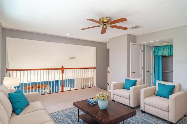 living room featuring carpet flooring, a ceiling fan, visible vents, and recessed lighting