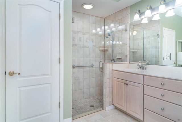 full bathroom featuring tile patterned floors, a shower stall, and vanity