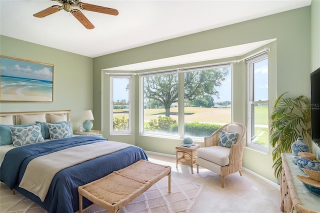 bedroom featuring baseboards, ceiling fan, and carpet