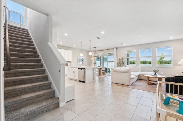 living room featuring recessed lighting, baseboards, light tile patterned floors, visible vents, and stairway