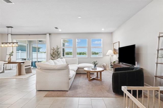 living area with recessed lighting, light tile patterned flooring, and visible vents
