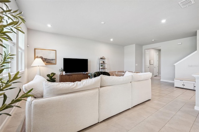 living room with recessed lighting, visible vents, and light tile patterned floors