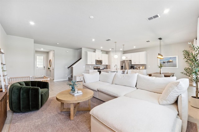 living room featuring visible vents and recessed lighting