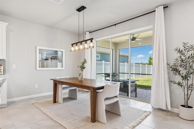dining space with baseboards, a ceiling fan, and light tile patterned flooring