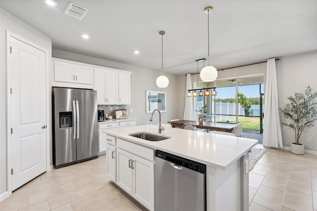 kitchen with visible vents, light countertops, a sink, light tile patterned floors, and stainless steel appliances