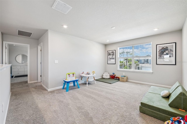 recreation room with baseboards, visible vents, and carpet