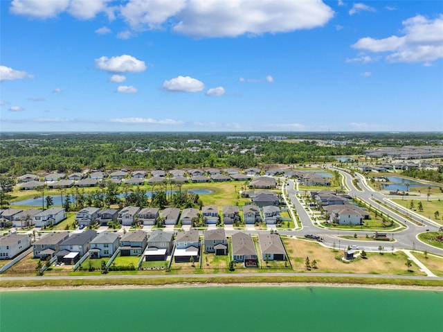 drone / aerial view with a residential view and a water view