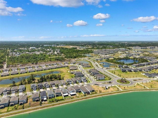 birds eye view of property with a water view and a residential view