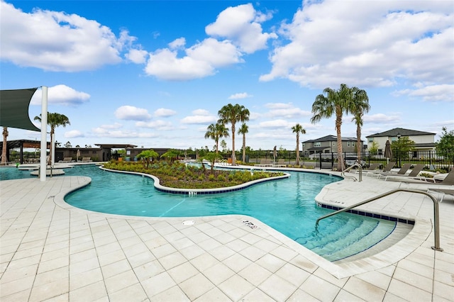 community pool featuring a patio and fence