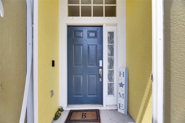 entrance to property with stucco siding