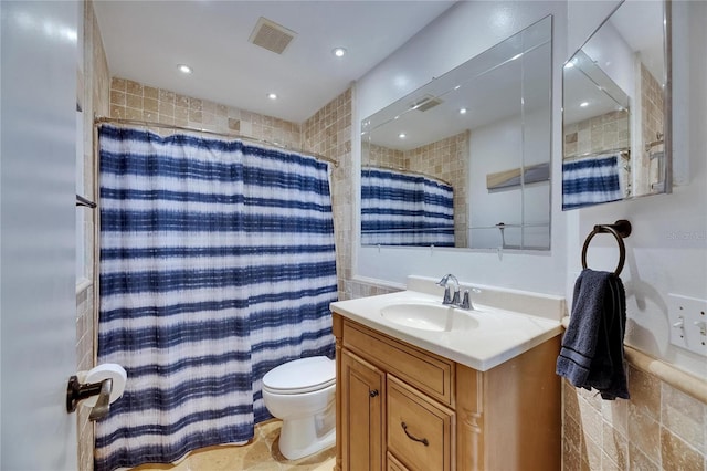 bathroom with tile walls, toilet, vanity, and a shower with curtain