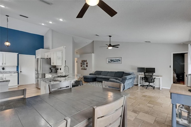 dining room with a ceiling fan, high vaulted ceiling, an office area, baseboards, and a textured ceiling