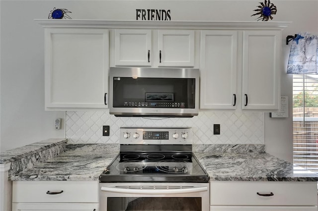 kitchen featuring appliances with stainless steel finishes, white cabinetry, and tasteful backsplash