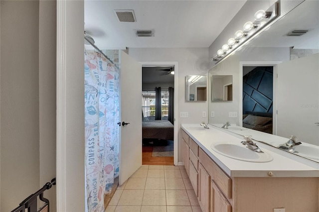 full bath with ensuite bath, double vanity, tile patterned floors, and a ceiling fan
