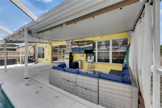 view of patio with outdoor lounge area and fence