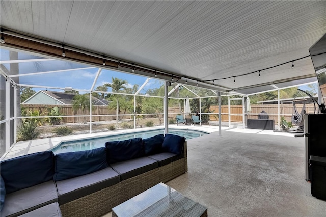 view of patio featuring a fenced backyard, outdoor lounge area, and glass enclosure