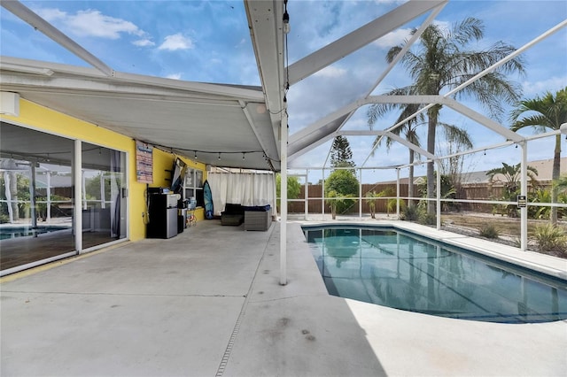view of pool with a patio area, a lanai, and a fenced backyard