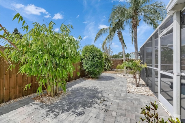 view of patio / terrace with a fenced backyard and glass enclosure