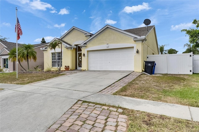 single story home featuring a garage, driveway, and stucco siding