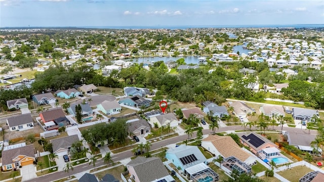 aerial view of property and surrounding area featuring nearby suburban area and a nearby body of water