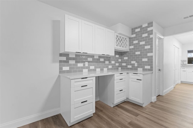 unfurnished office featuring light wood-style flooring and visible vents