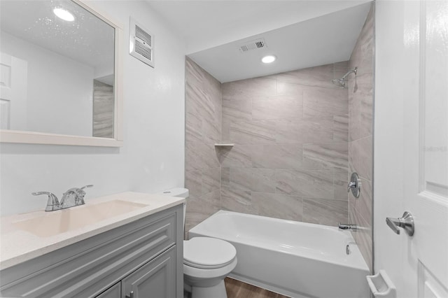 full bathroom featuring toilet, visible vents, vanity, and tub / shower combination