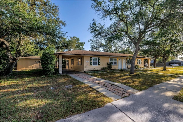 ranch-style house with a front yard, a carport, and driveway