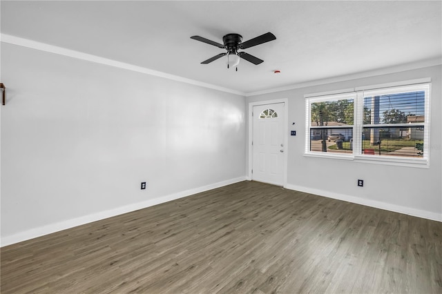 interior space featuring ceiling fan, ornamental molding, baseboards, and wood finished floors