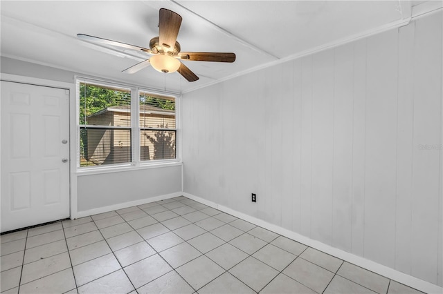 unfurnished room with baseboards, a ceiling fan, and ornamental molding
