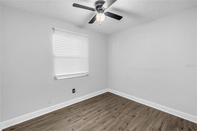unfurnished room featuring wood finished floors, baseboards, and a ceiling fan