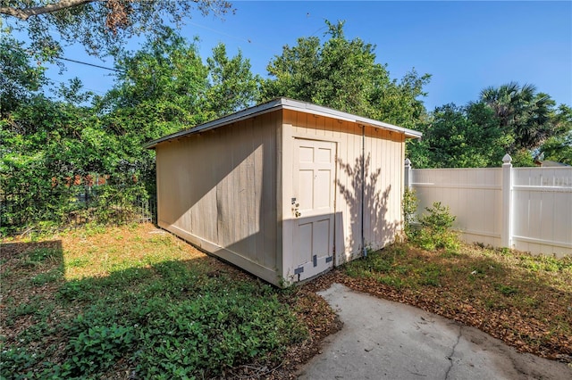 view of shed featuring fence