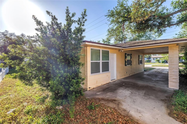 view of home's exterior featuring an attached carport and concrete block siding