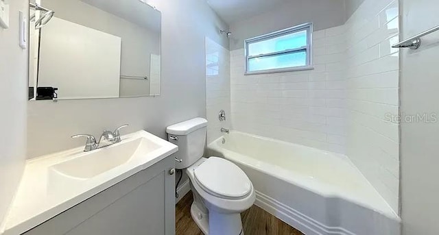 full bathroom featuring toilet, vanity, shower / tub combination, and wood finished floors