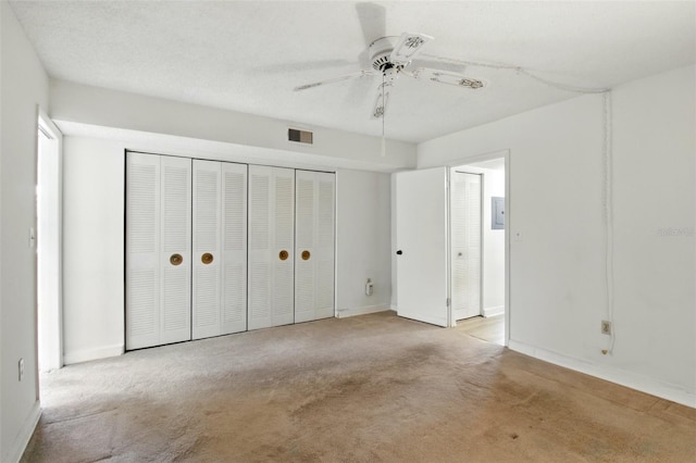 unfurnished bedroom featuring baseboards, visible vents, carpet floors, and electric panel