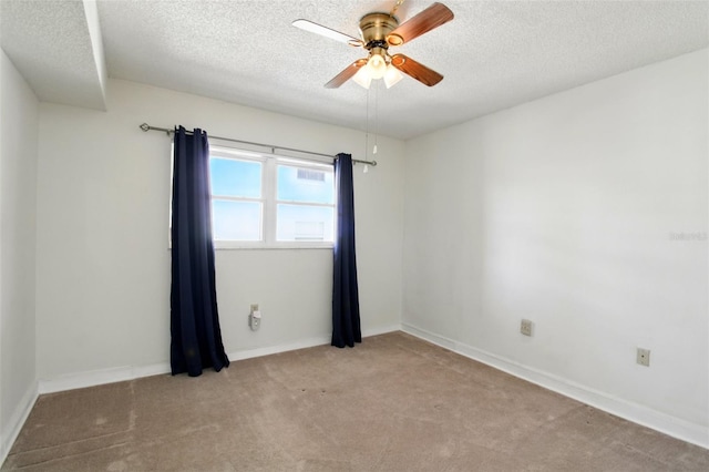 unfurnished room featuring a textured ceiling, a ceiling fan, and carpet