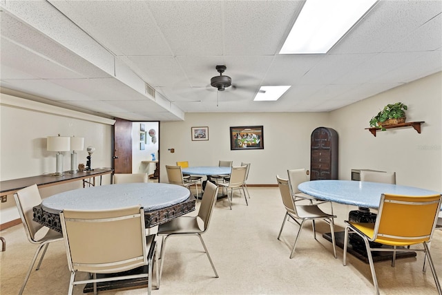 dining space with visible vents, a paneled ceiling, and baseboards