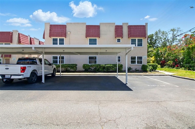 view of property featuring covered parking