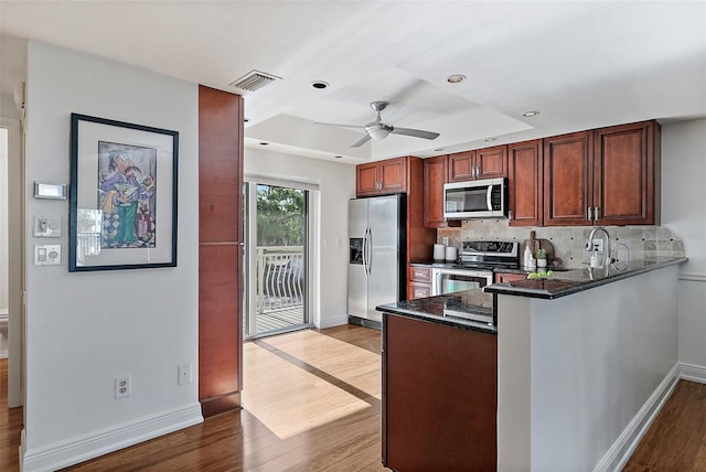 936 Pinellas Bayway S Unit T-5, Tierra Verde, FL 33715 - kitchen featuring a peninsula, visible vents, ceiling fan, dark wood-type flooring, and appliances with stainless steel finishes