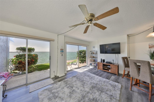 1301 Gulf Blvd Unit 107, Clearwater Beach, FL 33767 - living area featuring a textured ceiling, wood finished floors, and ceiling fan