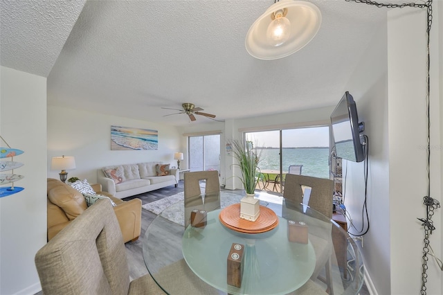 1301 Gulf Blvd Unit 107, Clearwater Beach, FL 33767 - dining room with a ceiling fan and a textured ceiling