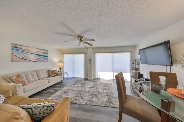 1301 Gulf Blvd Unit 107, Clearwater Beach, FL 33767 - living room with ceiling fan, wood finished floors, and a textured ceiling