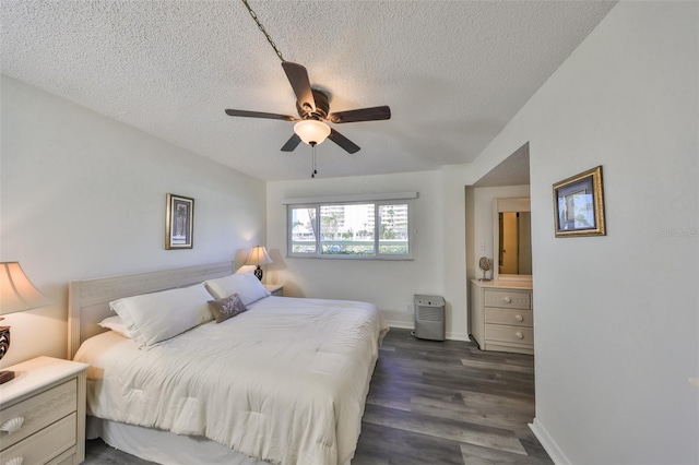 1301 Gulf Blvd Unit 107, Clearwater Beach, FL 33767 - bedroom featuring a textured ceiling, dark wood-style flooring, baseboards, and ceiling fan