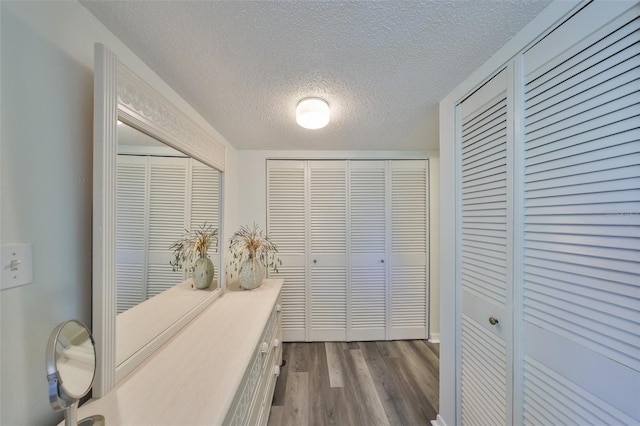 1301 Gulf Blvd Unit 107, Clearwater Beach, FL 33767 - hall with a textured ceiling and dark wood-style flooring