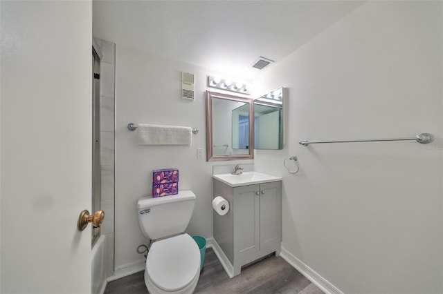 1301 Gulf Blvd Unit 107, Clearwater Beach, FL 33767 - full bath with vanity, wood finished floors, toilet, baseboards, and shower / bath combination