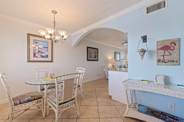 19417 Gulf Blvd Unit E217, Indian Rocks Beach, FL 33785 - dining area featuring arched walkways, ornamental molding, a chandelier, and visible vents