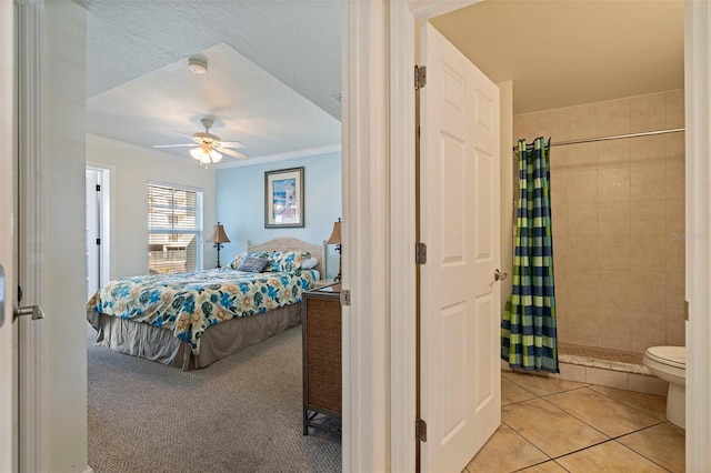 19417 Gulf Blvd Unit E217, Indian Rocks Beach, FL 33785 - bedroom featuring a ceiling fan, ornamental molding, ensuite bathroom, and light tile patterned flooring