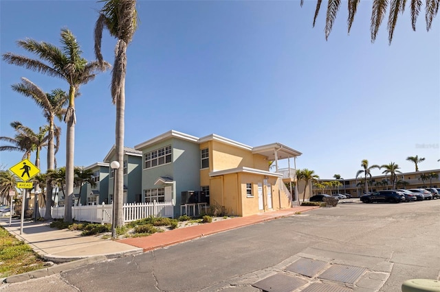 19417 Gulf Blvd Unit E217, Indian Rocks Beach, FL 33785 - view of property featuring uncovered parking and fence