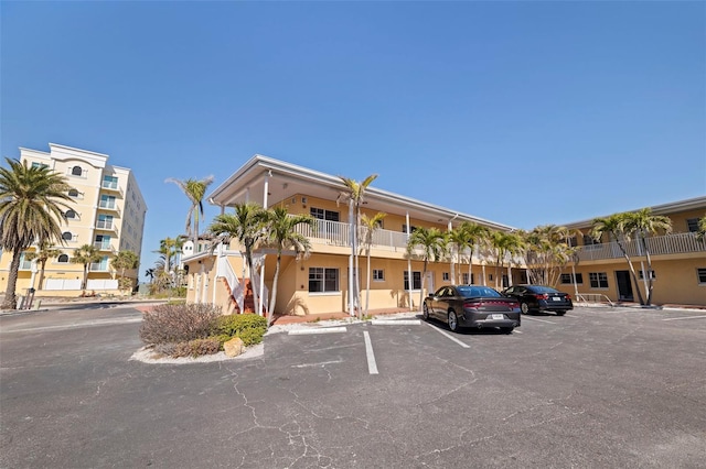 19417 Gulf Blvd Unit E217, Indian Rocks Beach, FL 33785 - view of building exterior with uncovered parking