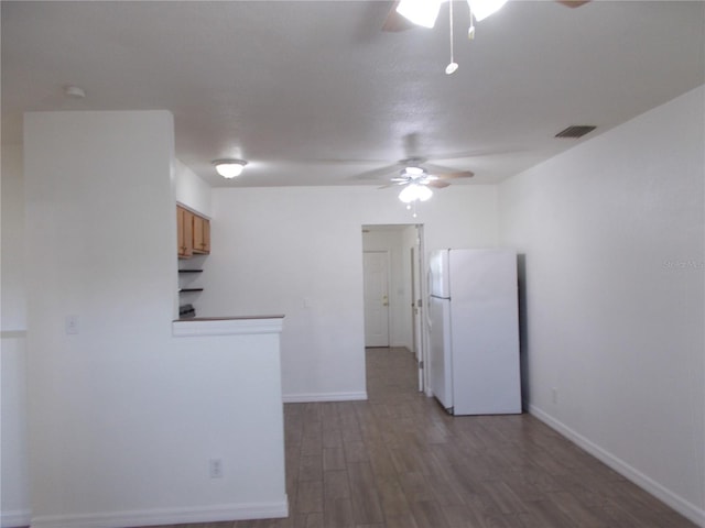 433 73rd Ave N, Saint Petersburg, FL 33702 - kitchen with baseboards, freestanding refrigerator, visible vents, a ceiling fan, and wood finished floors