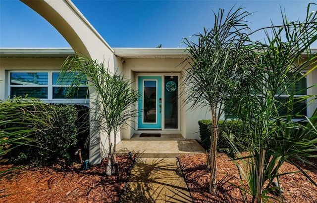 entrance to property with stucco siding